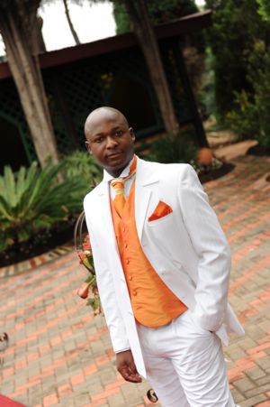 White suit with orange accessories